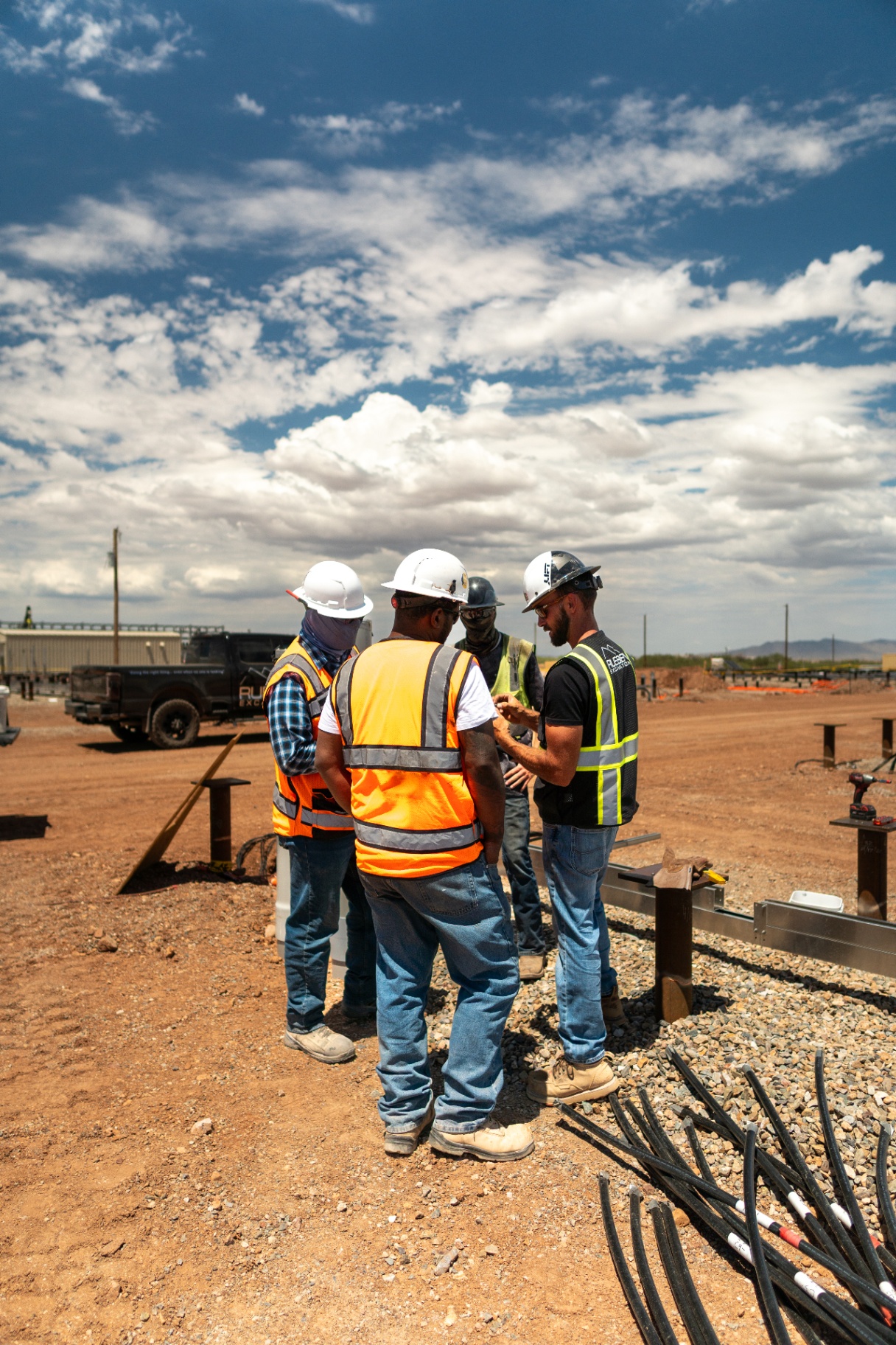 Rueben Excavation crew safety huddle on solar pile array site with Elgin Power Solutions partners